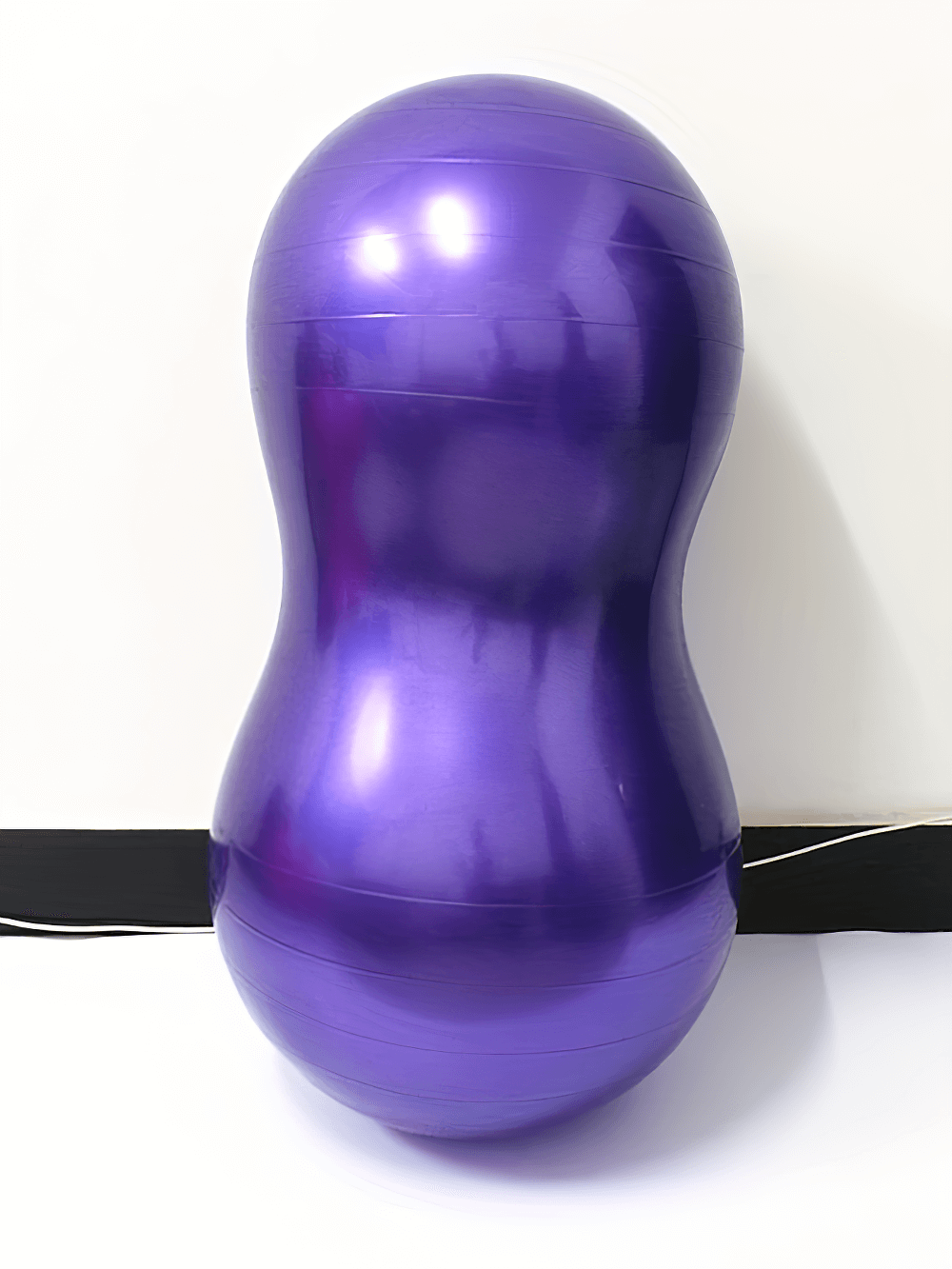 Purple anti-explosion peanut yoga ball for fitness, ideal for core strength, stability, and posture improvement exercises.