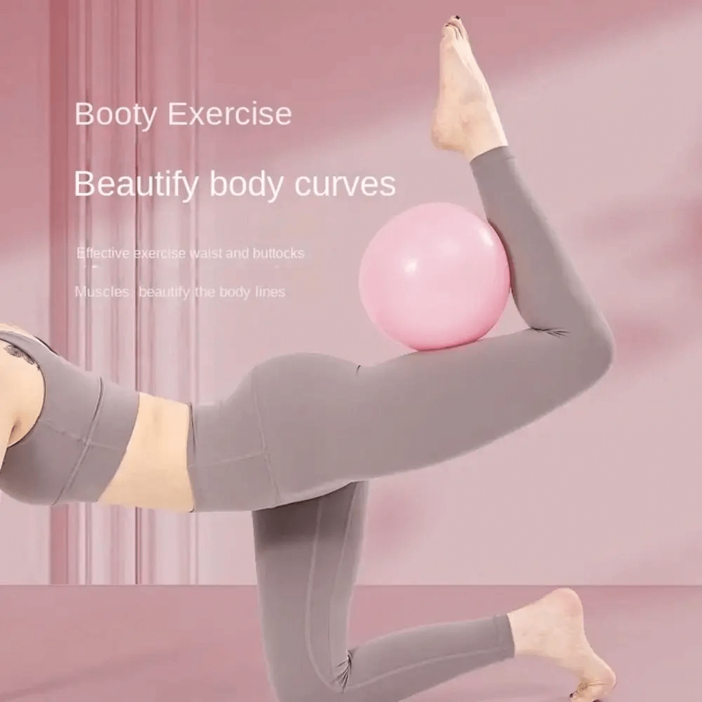Woman using anti-explosion Pilates yoga ball for leg workout, enhancing body curves and flexibility in home gym settings.