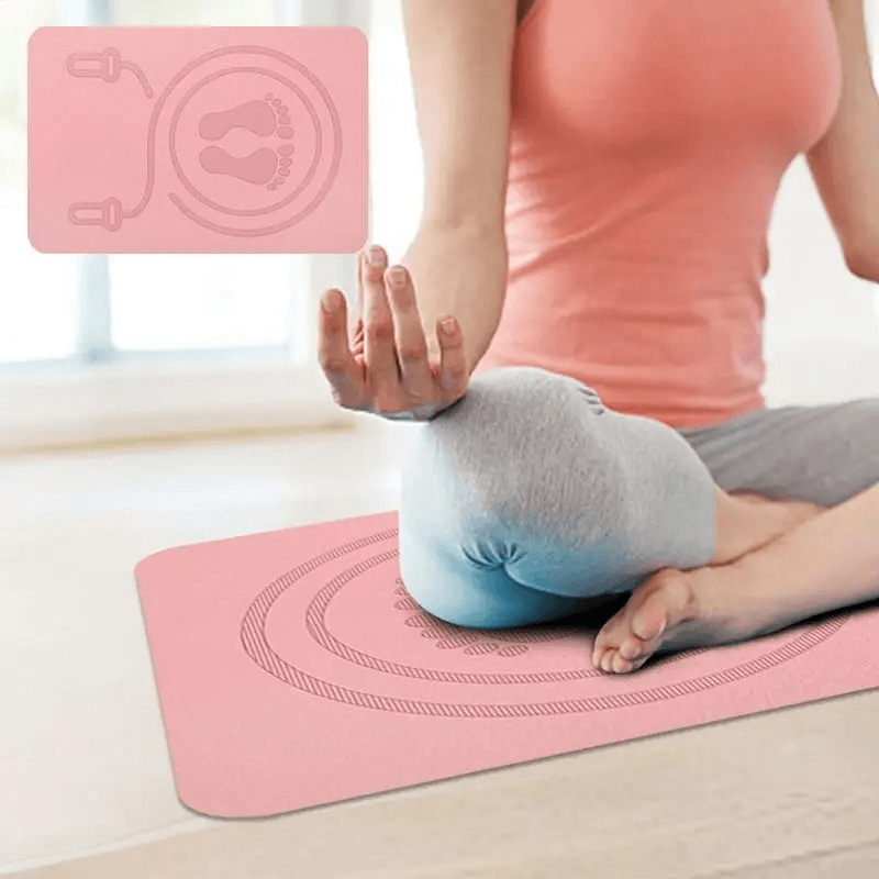 Woman practicing yoga on a pink TPE non-slip mat, perfect for exercise and skipping, showcasing shock absorption and stability.