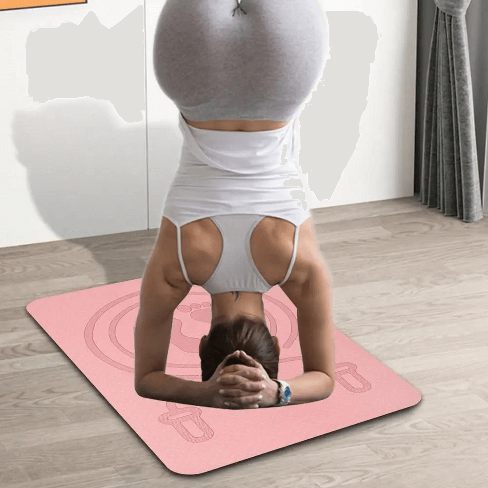 Person practicing headstand on pink anti-slip TPE yoga mat for exercise, showcasing stability and shock absorption.