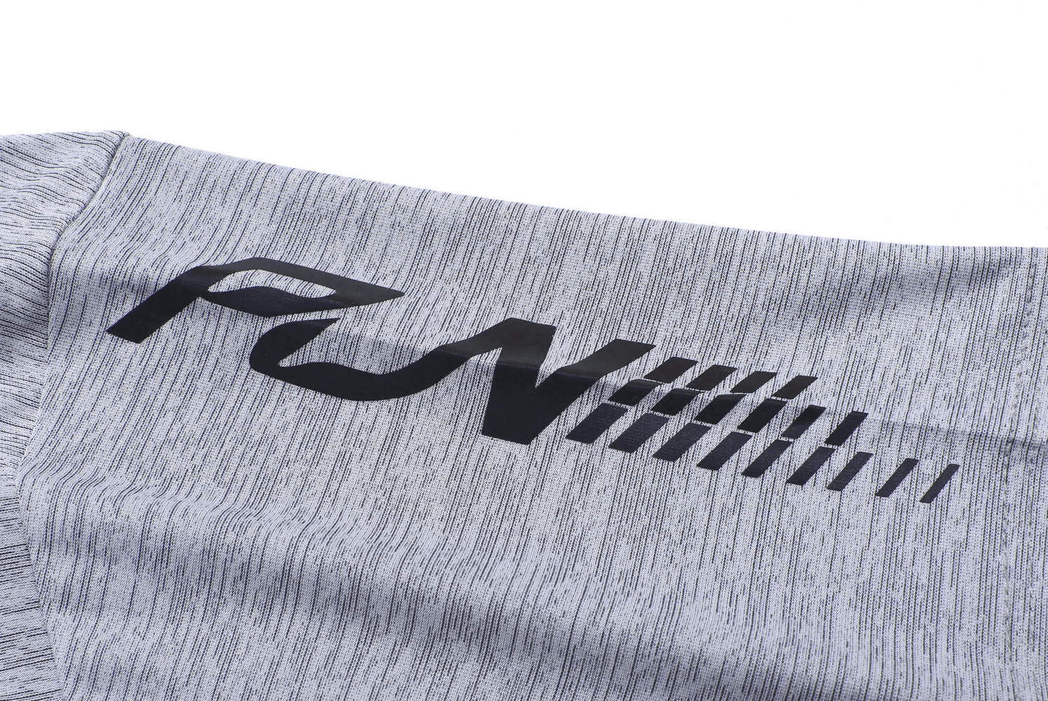 Close-up of sporty breathable fabric on a men's gray t-shirt with 'RUN' text, featuring quick-dry technology for athletic wear.