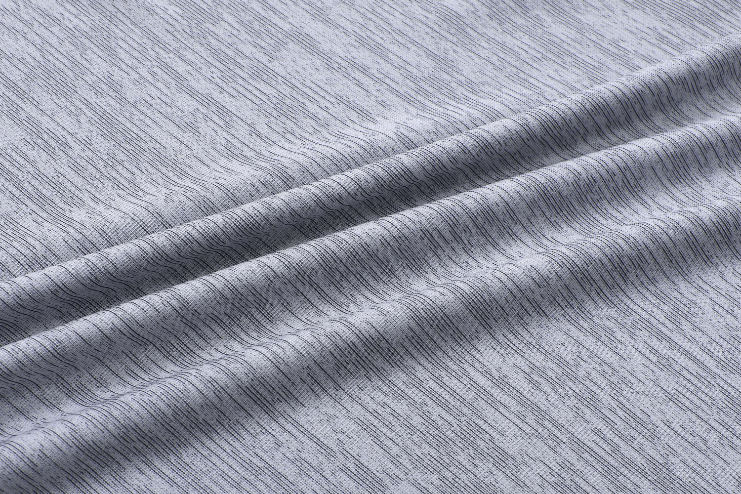 Close-up of gray breathable quick dry fabric for athletic t-shirts showcasing its sporty texture and high-performance material.