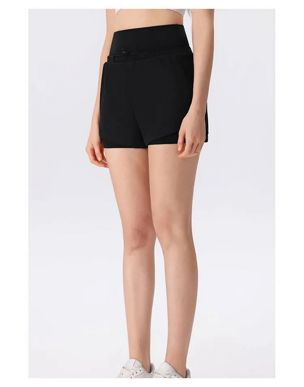 Woman wearing black athletic high waist shorts for warm weather, showcasing lightweight, breathable, quick-dry fabric ideal for gym workouts.