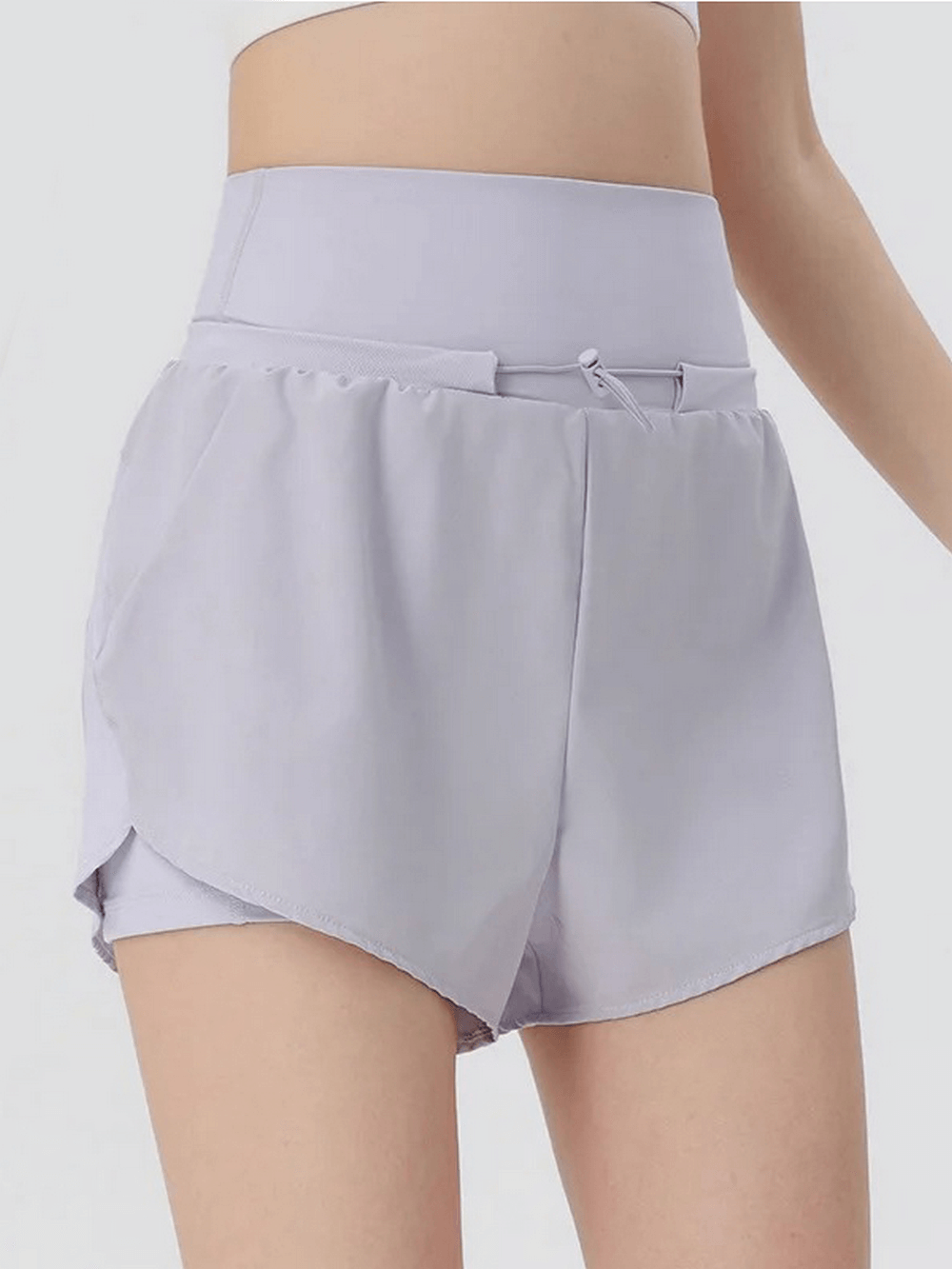 Light purple athletic high waist shorts for women, perfect for gym and warm weather, featuring a breathable and quick-drying design.
