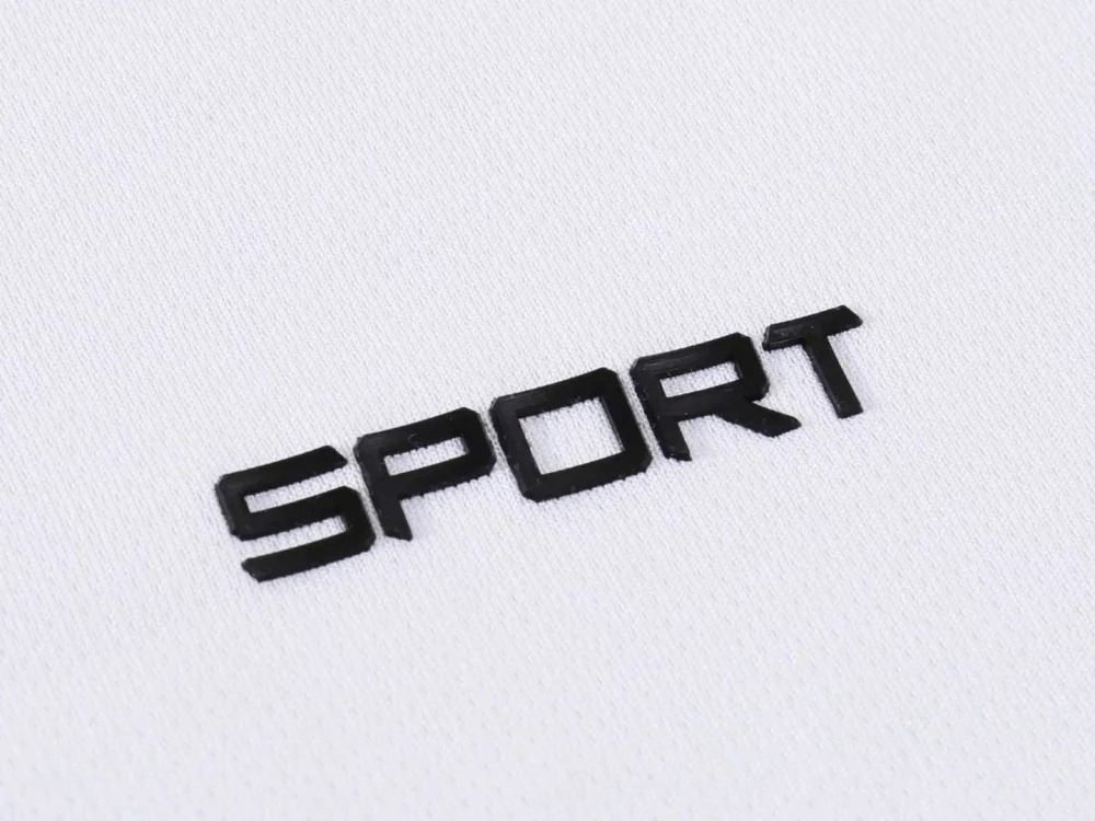 Black "Sport" lettering on white breathable polyester fabric, ideal for athletic apparel and activewear design.