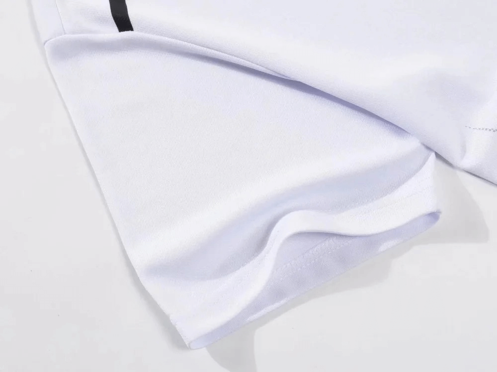 Close-up of a white polyester athletic short, part of the O-Neck sportswear set for men, highlighting breathable material and sleek design.