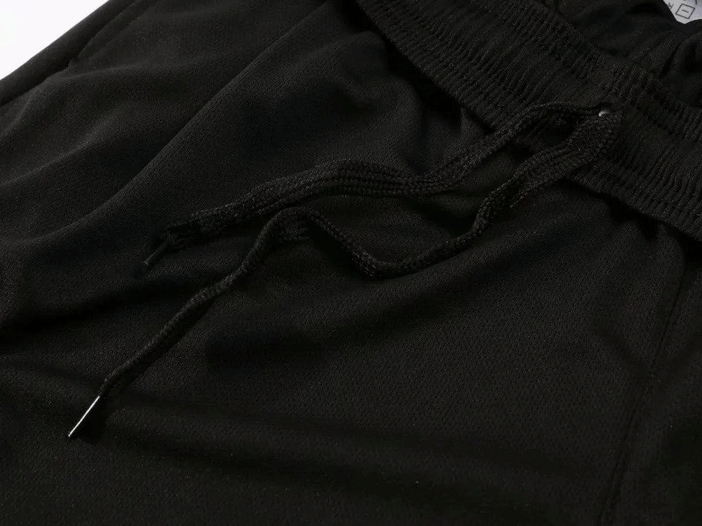 Close-up of black sports drawstring pants from athletic O-neck sportswear set SF2017, made of breathable polyester for workouts.