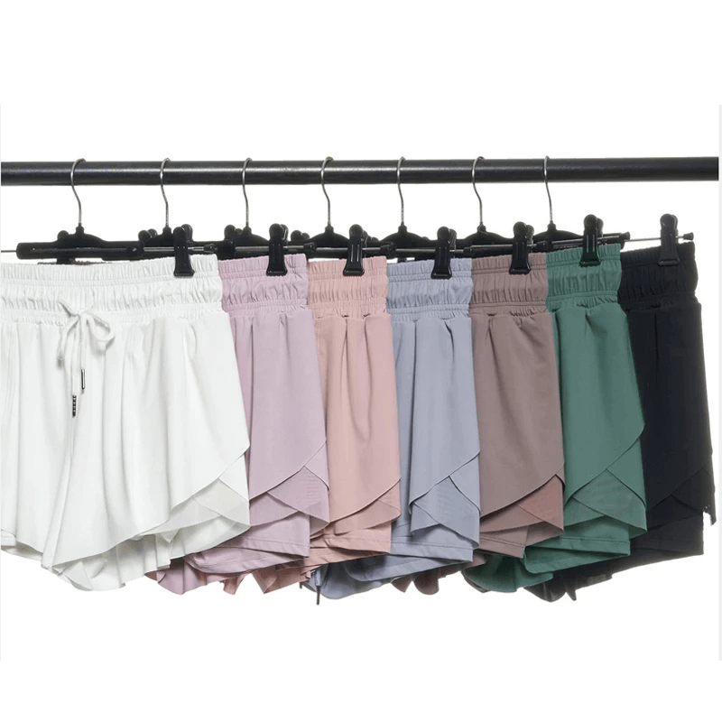 Colorful dual-layer shorts for women in various shades on a clothing rack, perfect for athletic activities and running.