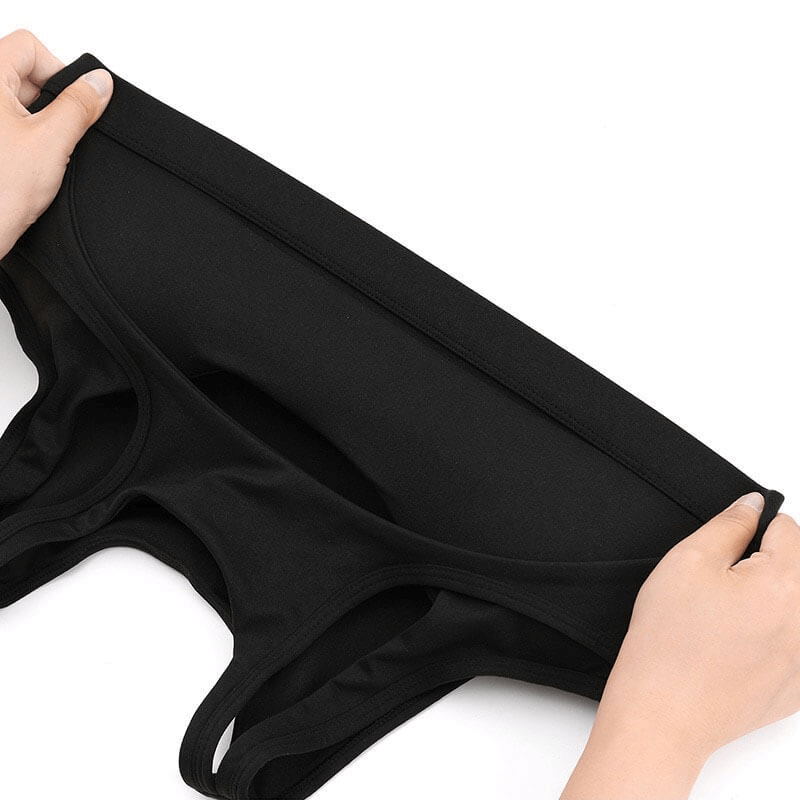 Hands stretching a black athletic women's sports bra made from durable quick-dry fabric, perfect for yoga and running activities.