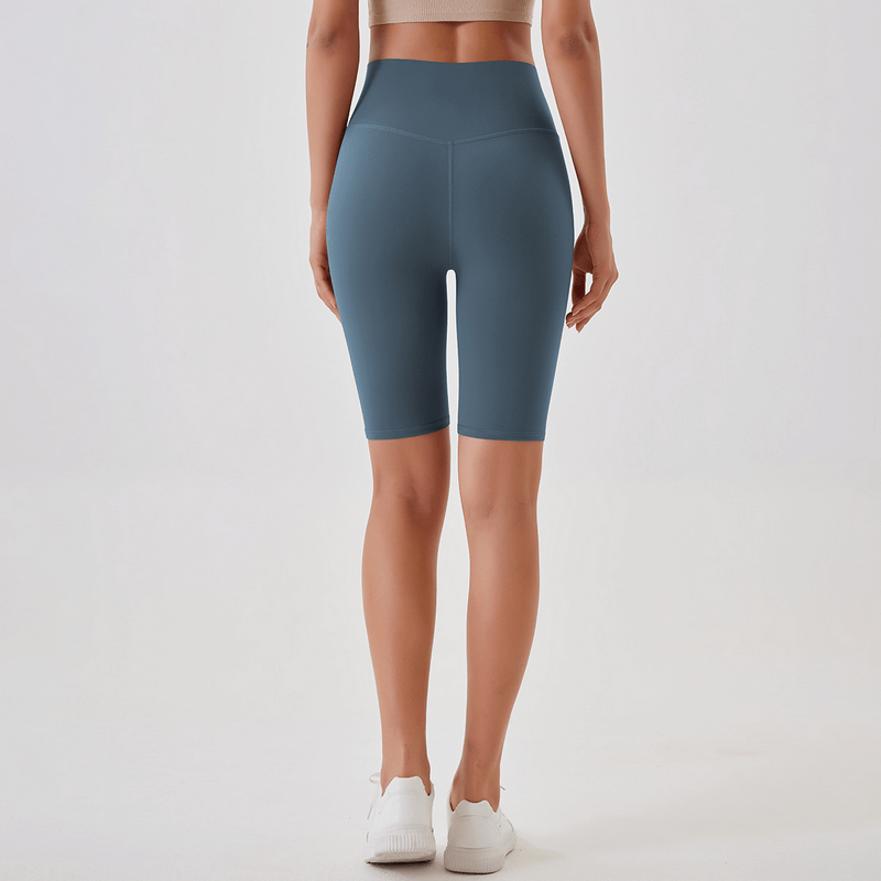Back view of a woman wearing blue high-waisted athletic shorts, perfect for running and yoga, showcasing comfort and fit.