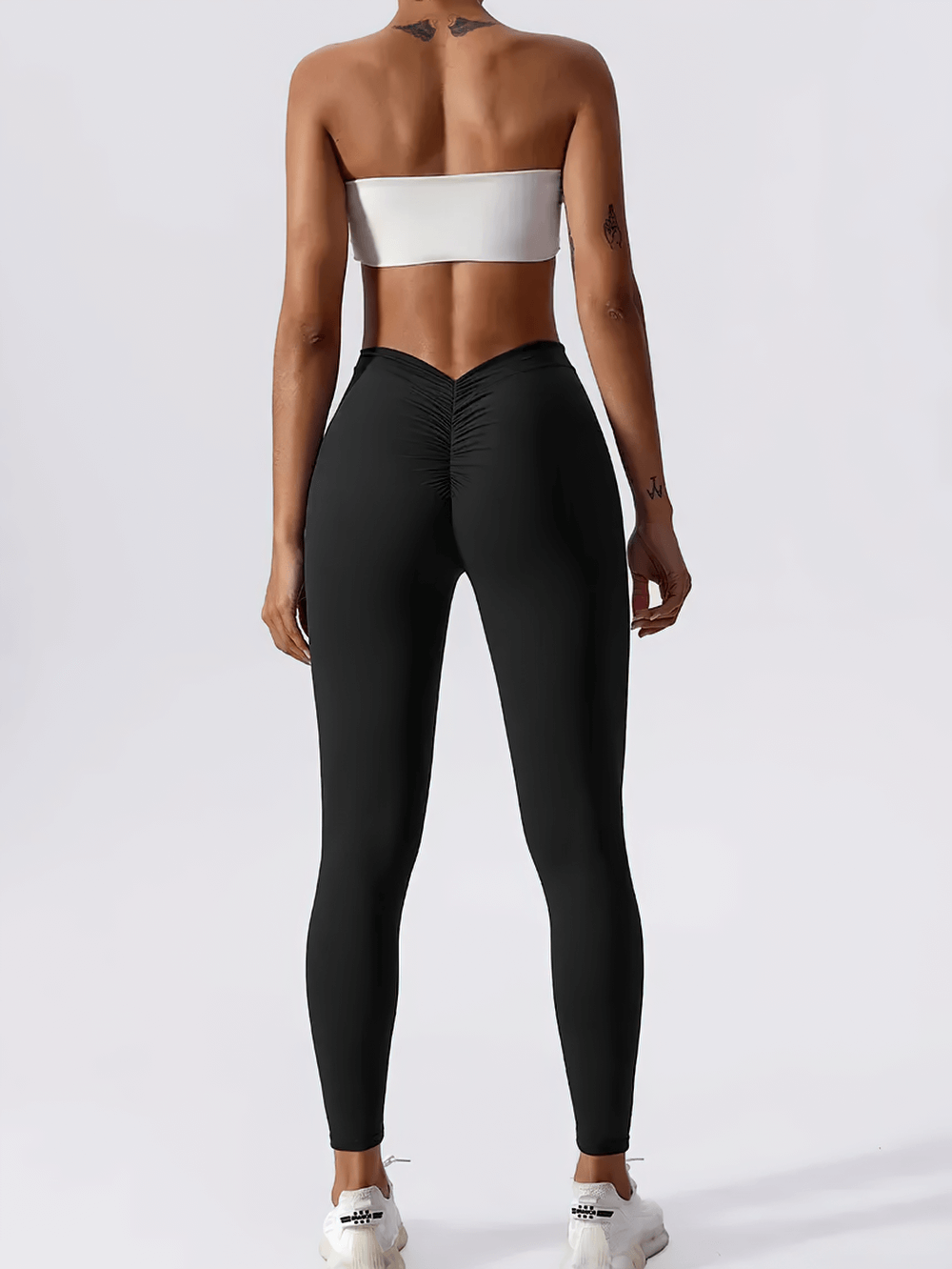 Back view of woman wearing Back V-Waist Hip Lift Yoga Leggings for Women - SF4006 with ruched back design enhancing curves.