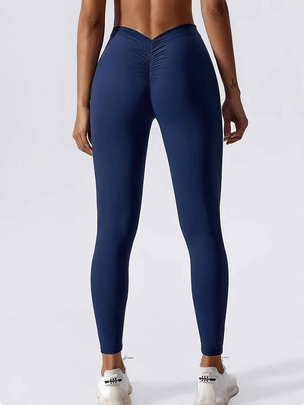 Back view of woman wearing Back V-Waist Hip Lift Yoga Leggings for Women - SF4006 in navy, showcasing ruched back seam and V-waist design.