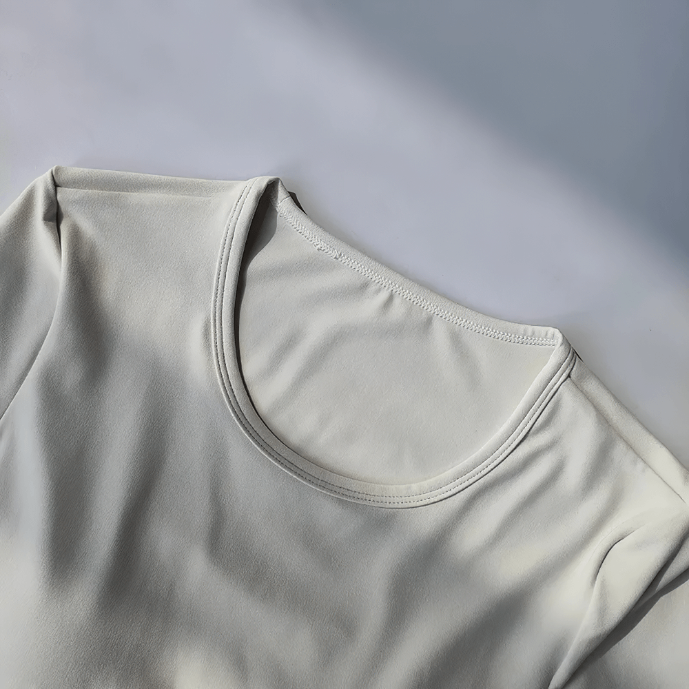 Backless Hollow Long Sleeve Yoga Top with Pads - SF4134 in breathable nylon and spandex, perfect for stylish yoga and fitness routines.