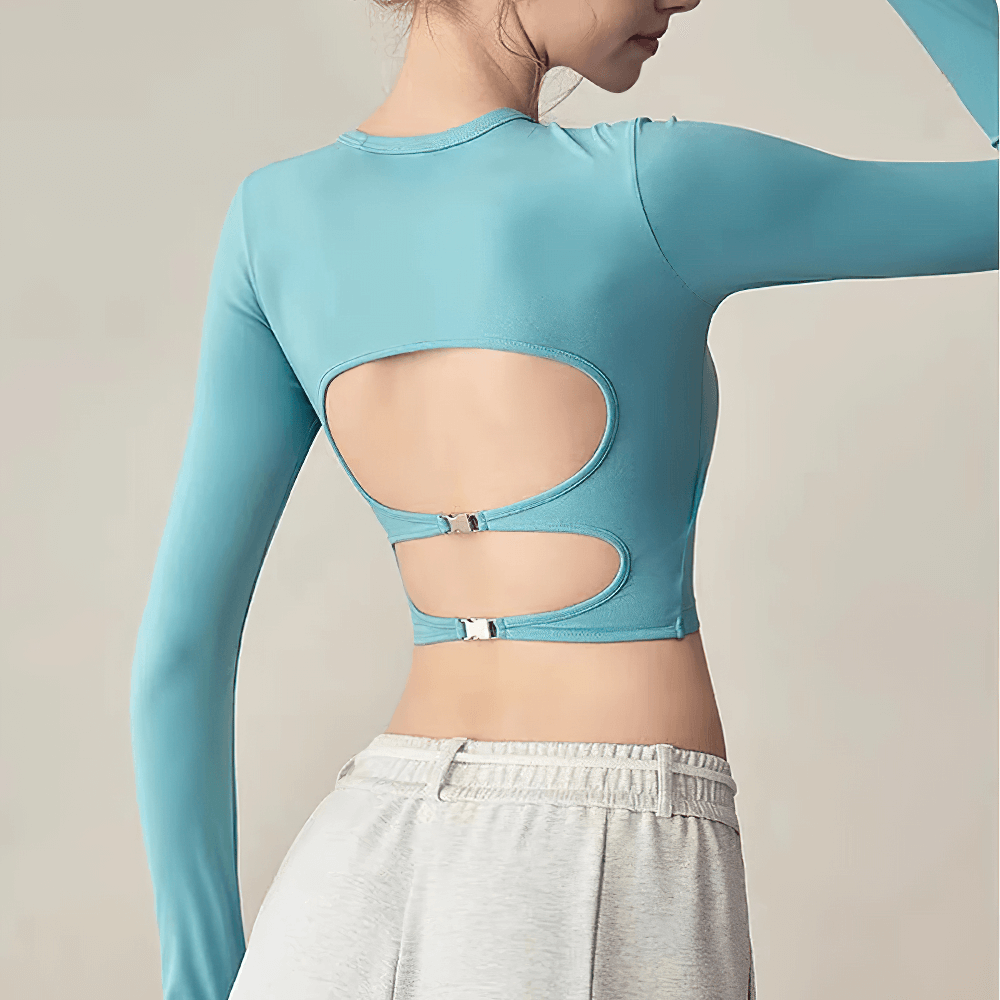 Woman wearing Backless Hollow Long Sleeve Yoga Top with Pads - SF4134, showcasing backless cut-out design in blue color.