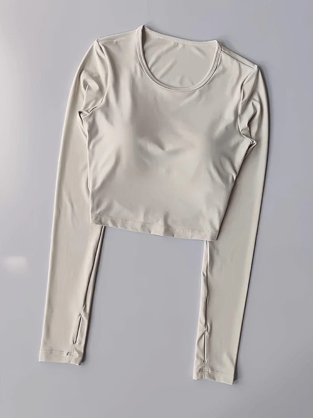 Backless Hollow Long Sleeve Yoga Top with Pads - SF4134 laid flat; stylish, breathable, and perfect for workouts.