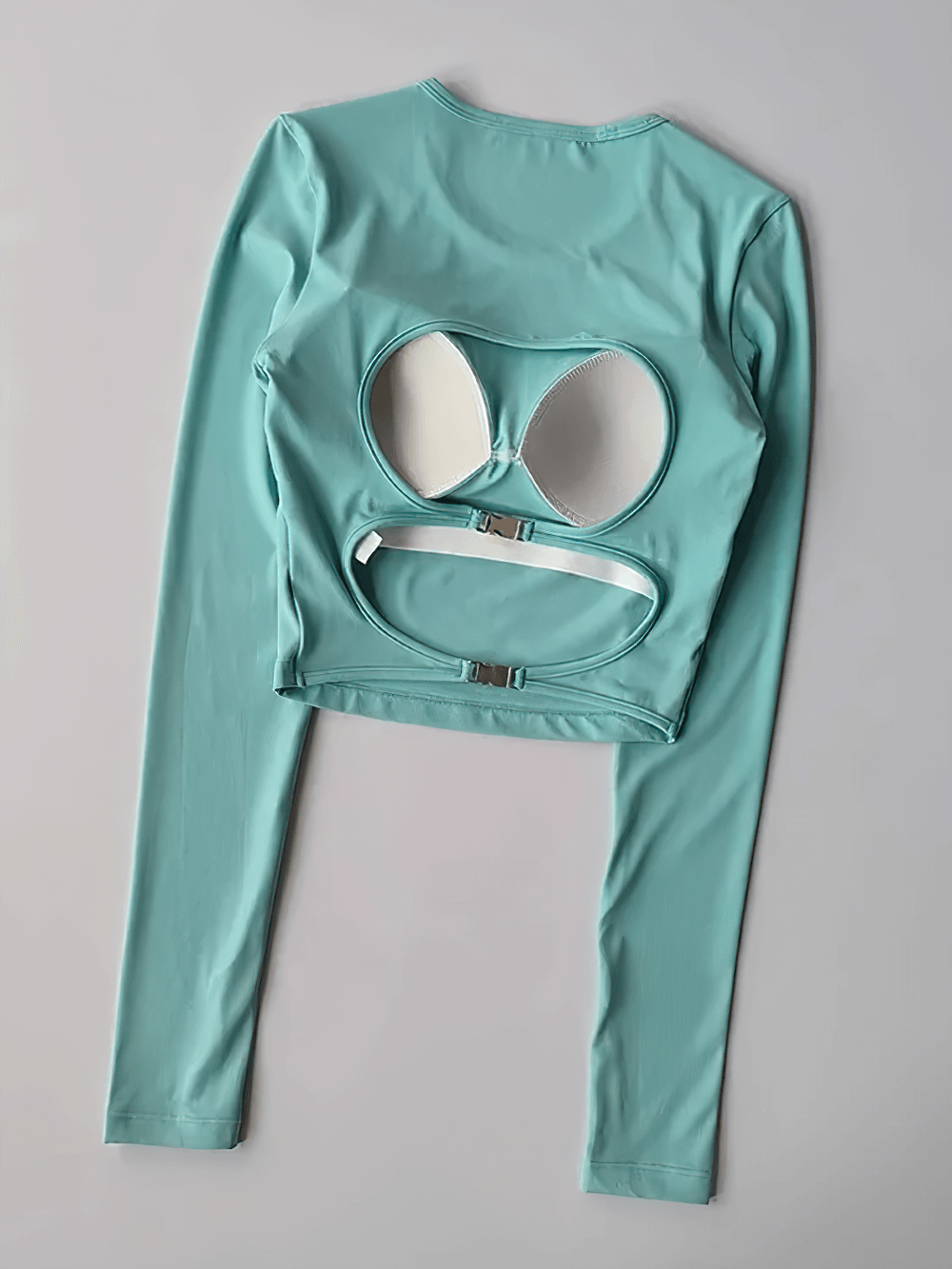 Backless Hollow Long Sleeve Yoga Top with Pads - SF4134 in teal green, highlighting the stylish and functional cut-out back design.