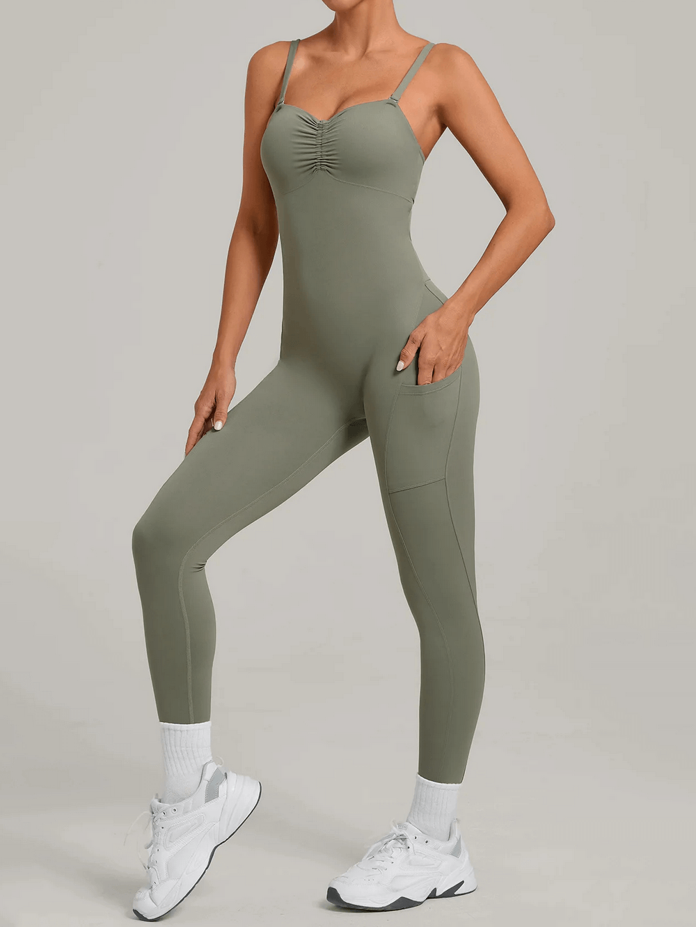 Model wearing the Backless Yoga Jumpsuit with Pockets and Halter - SF4261, showcasing the seamless design and side pockets.