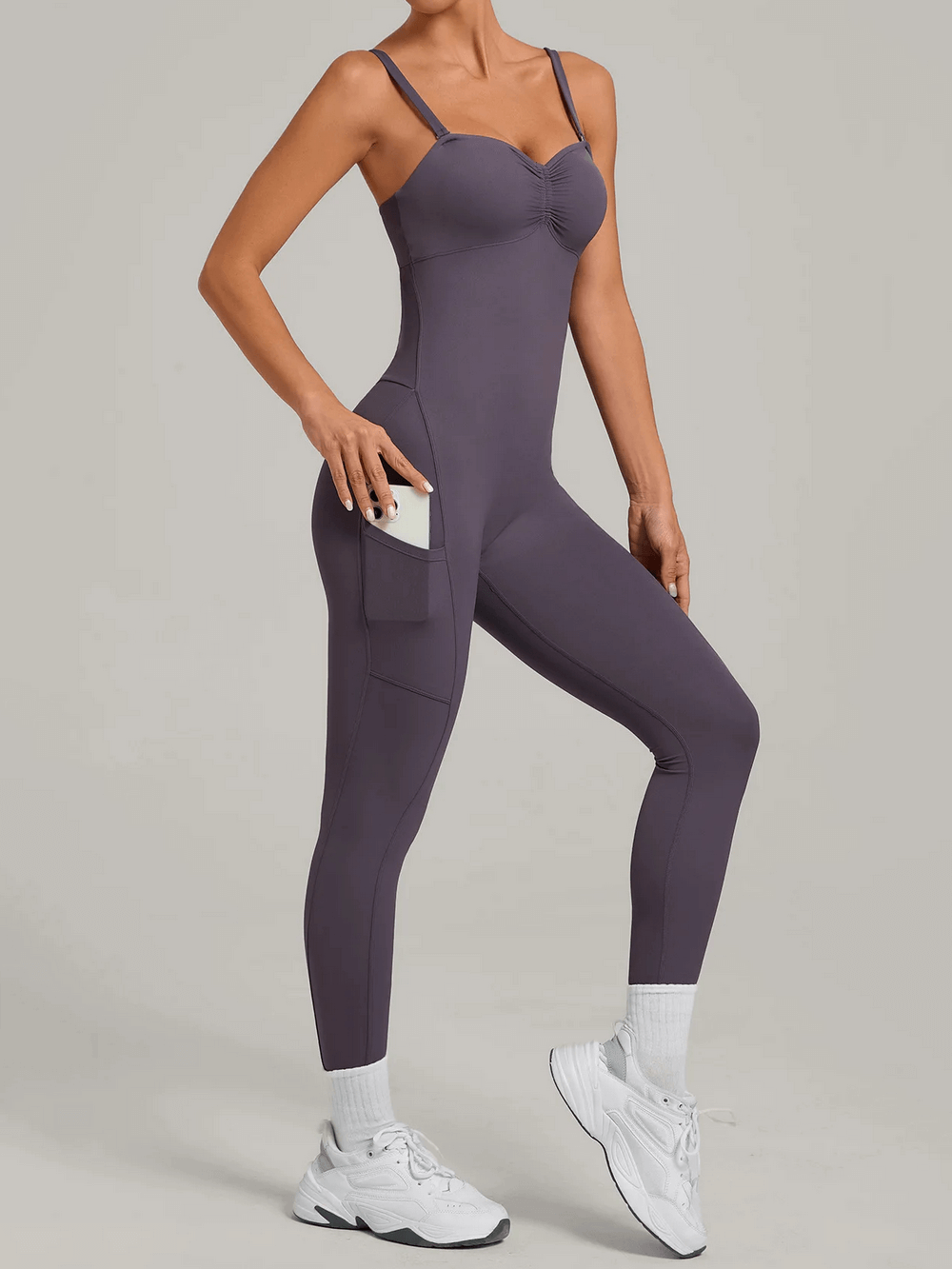 Backless Yoga Jumpsuit with Pockets and Halter - SF4261 in gym setting showcasing side pockets, seamless fit, and activewear style.