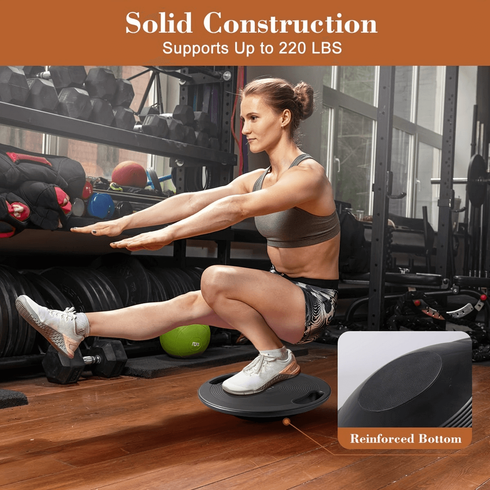 Woman using balance board for stability training in gym, supporting up to 220 lbs. Features a reinforced bottom for safety.