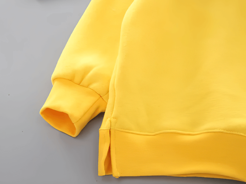 Close-up of yellow Bear Ears Hoodie with Zip and Side Slits - SF3655, showing sleeve and stylish side slit detail.