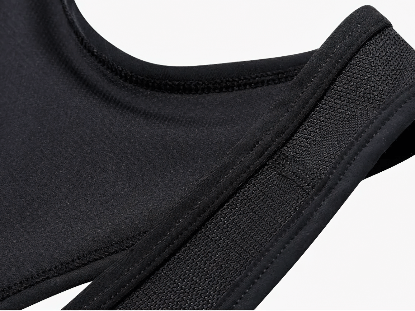 Close-up of stretchy black fabric strap from men's cycling apparel, showcasing texture and quality for optimal comfort on rides.