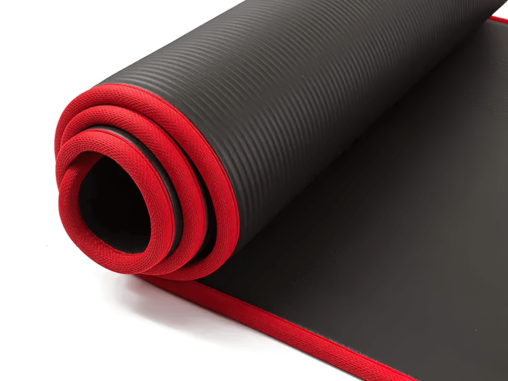 Black and red thick yoga mat for fitness, eco-friendly, non-slip surface, perfect for yoga and pilates, rolled up for storage.