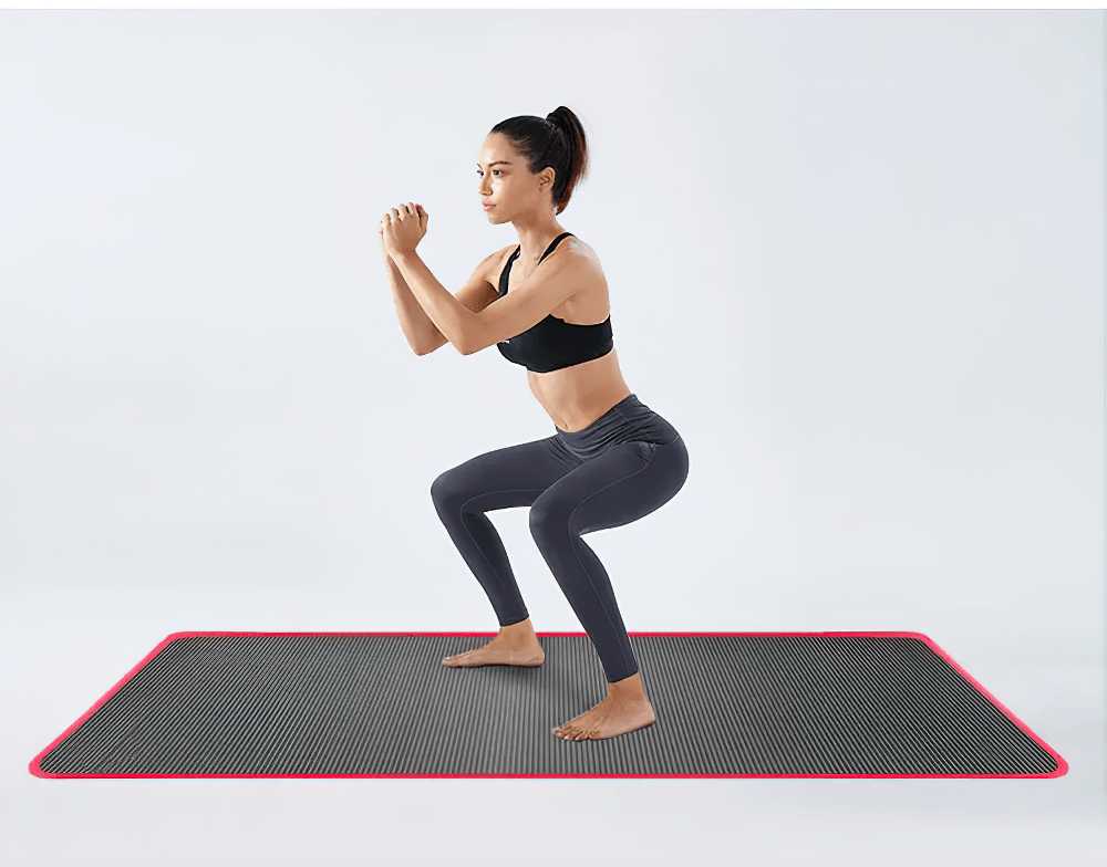 Woman doing squats on black and red non-slip yoga mat (SF3277), ideal for fitness, stretching, pilates, and home workouts.