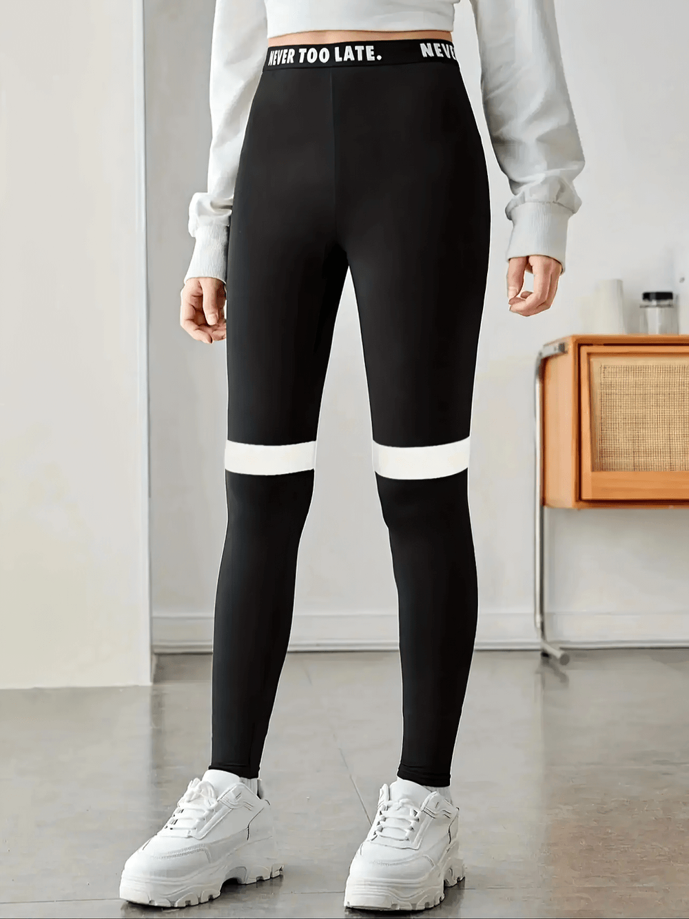 Girl wearing Black and White Contrast Waistband Sports Leggings - SF3675 for yoga and gym, featuring 'Never Too Late' waistband.