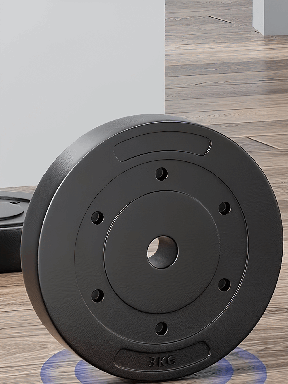 Durable black dumbbell weight plate for strength training, perfect for gym and home workouts, shown on a wooden floor.