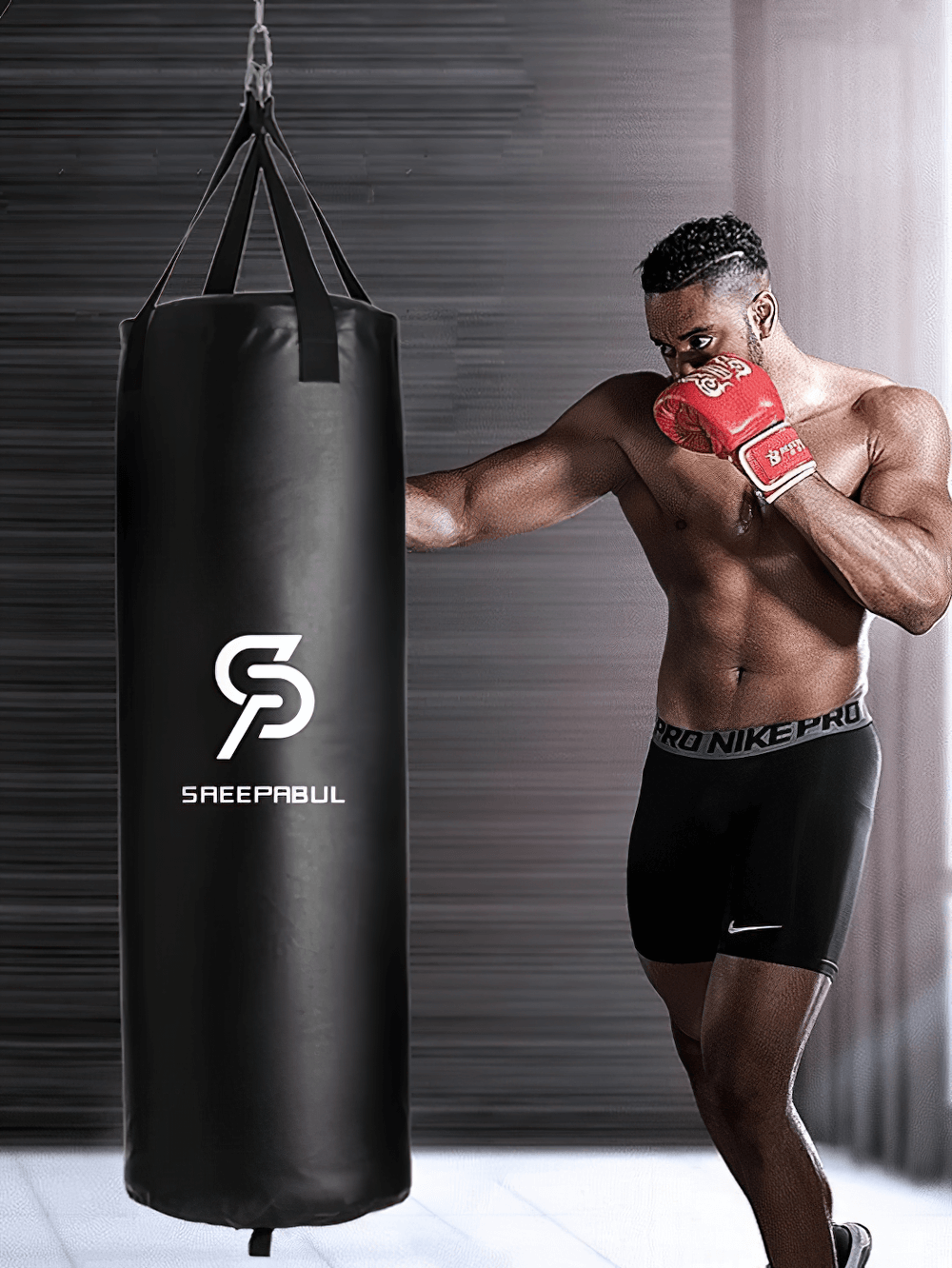Man training with a black hanging boxing punching bag SF2721, perfect for intense workouts, made from durable synthetic leather PVC.