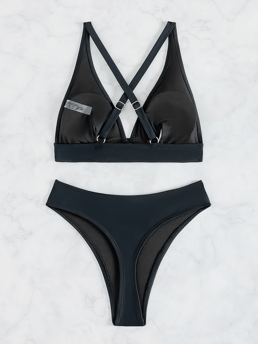 Black Plunge Bikini Set with Mid Waist Bottoms - SF4757 displayed on a marble background, featuring cross-back straps.