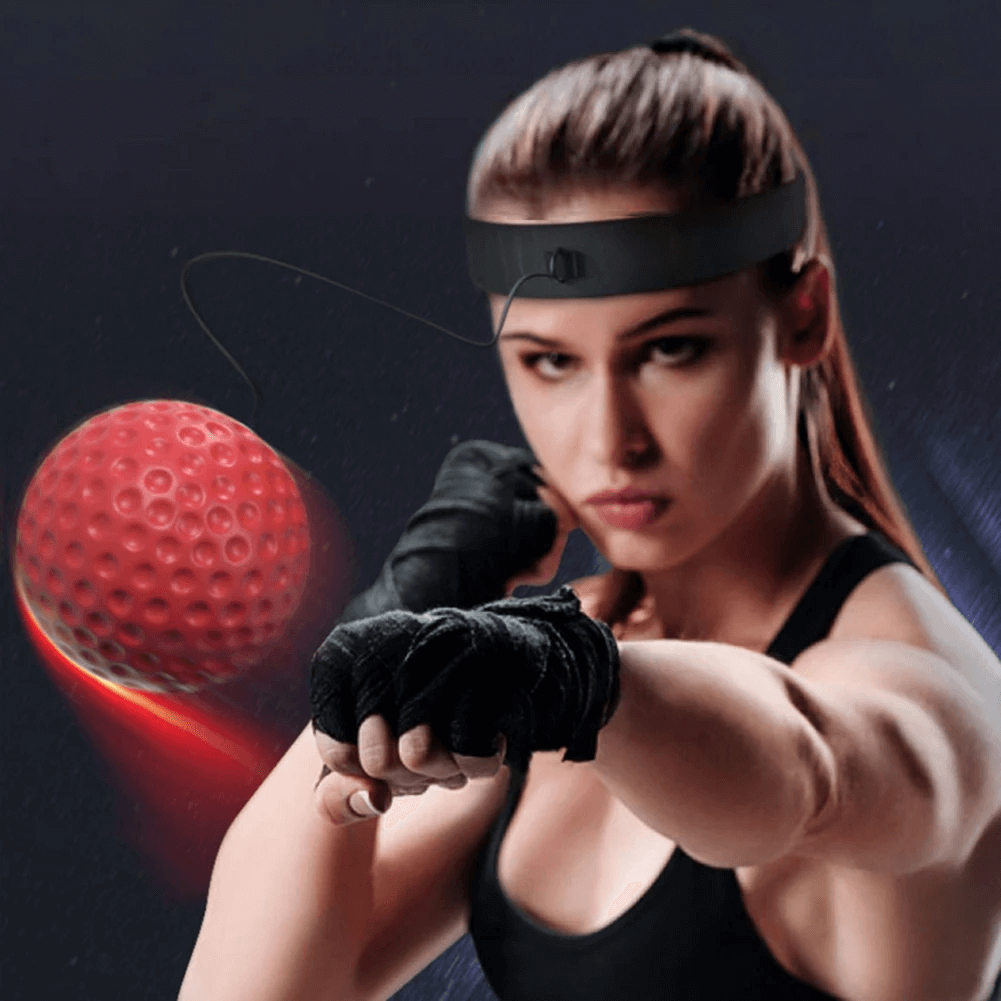 Woman using a boxing reflex ball and headband for MMA training, enhancing speed and hand-eye coordination. Ideal for fitness.