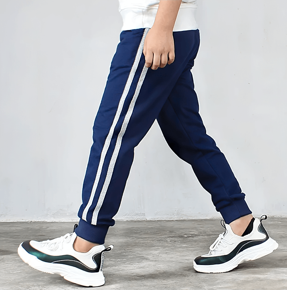 Boys Athletic Jogger Sweatpants with Pockets - SF3611, navy blue pants with stripe, side view, worn by a child in sneakers.