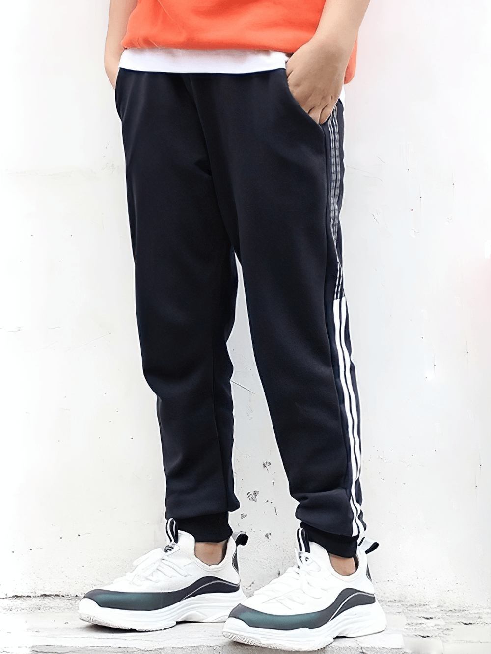 Boy wearing Boys Athletic Jogger Sweatpants with Pockets - SF3611, made of cotton and polyester, featuring side pockets and elastic waistband.
