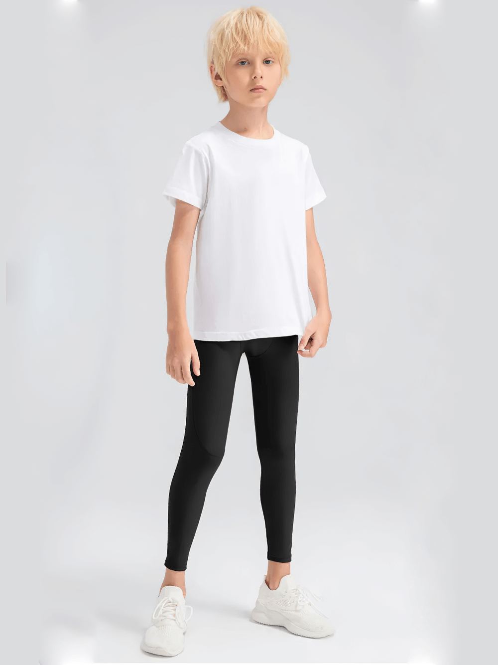 Young boy wearing Boys Compression Sports Leggings for Training - SF3794, perfect for active sports and workouts, with a white t-shirt.