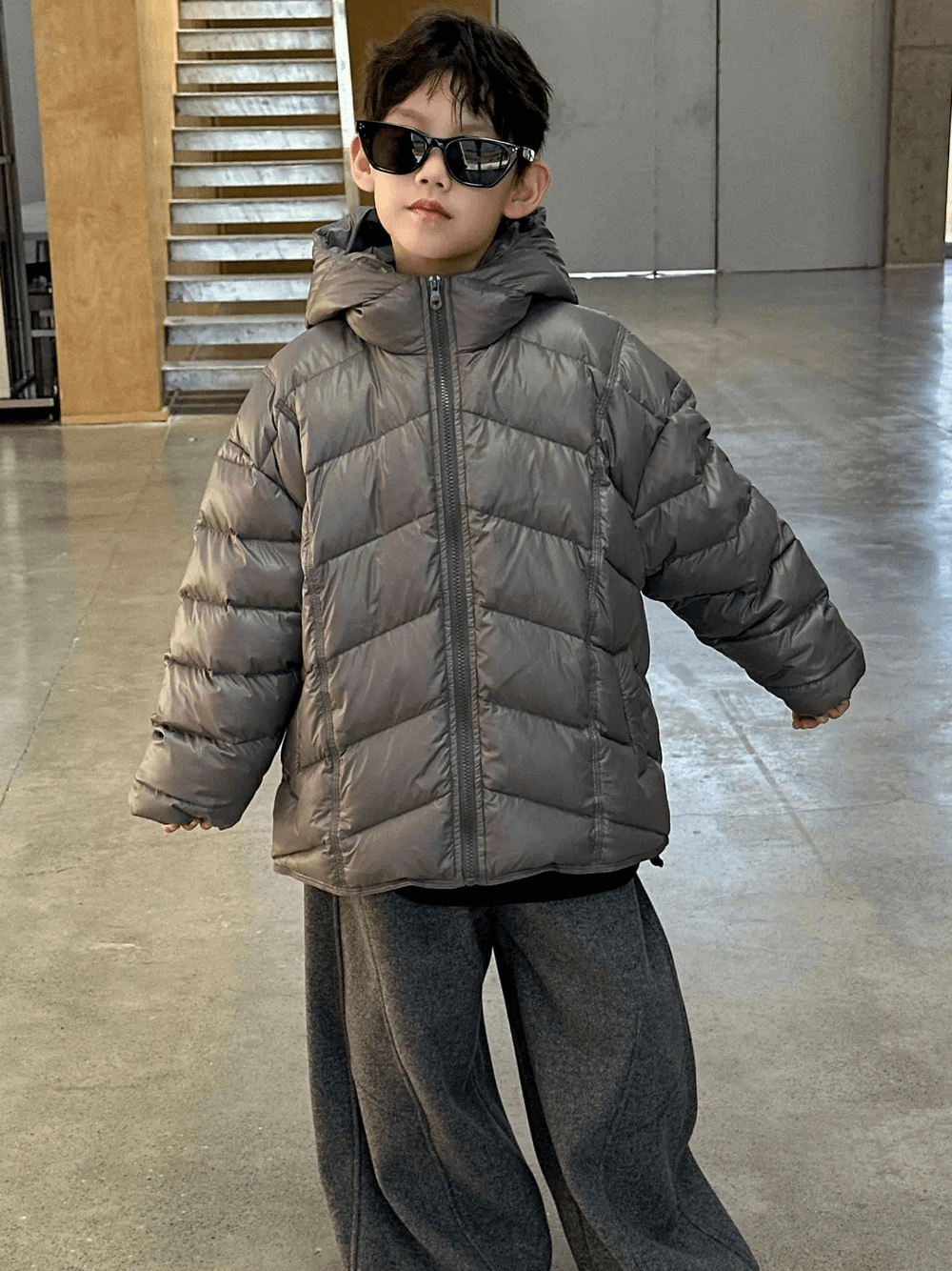 Boy wearing Boys Hooded Down Puffer Jacket With Zipper - SF3638 in a modern indoor setting, showcasing warm winter fashion.