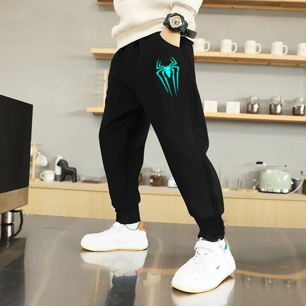 Boy wearing Boys Sporty Jogger Pants with Luminous Prints - SF3724, showcasing a luminous spider design and loose fit for active wear.