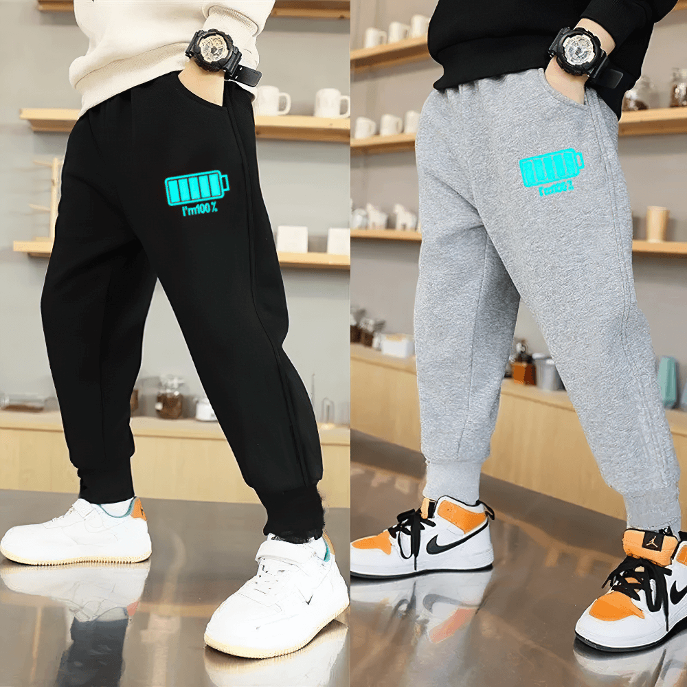 Boys Sporty Jogger Pants with Luminous Prints - SF3724 featuring elastic waist, pockets, and luminous lightning graphics in a cozy setting.