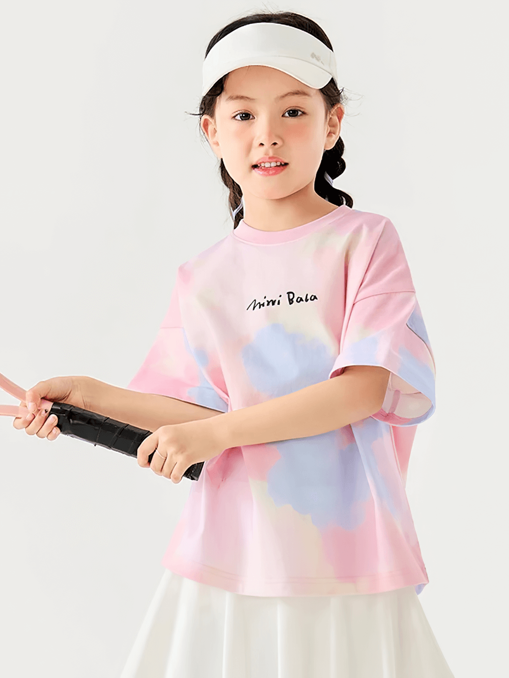 Young girl in a playful pose wearing a Breathable Cotton Tie-Dye Tee for Boys and Girls - SF3683, holding a tennis racket.