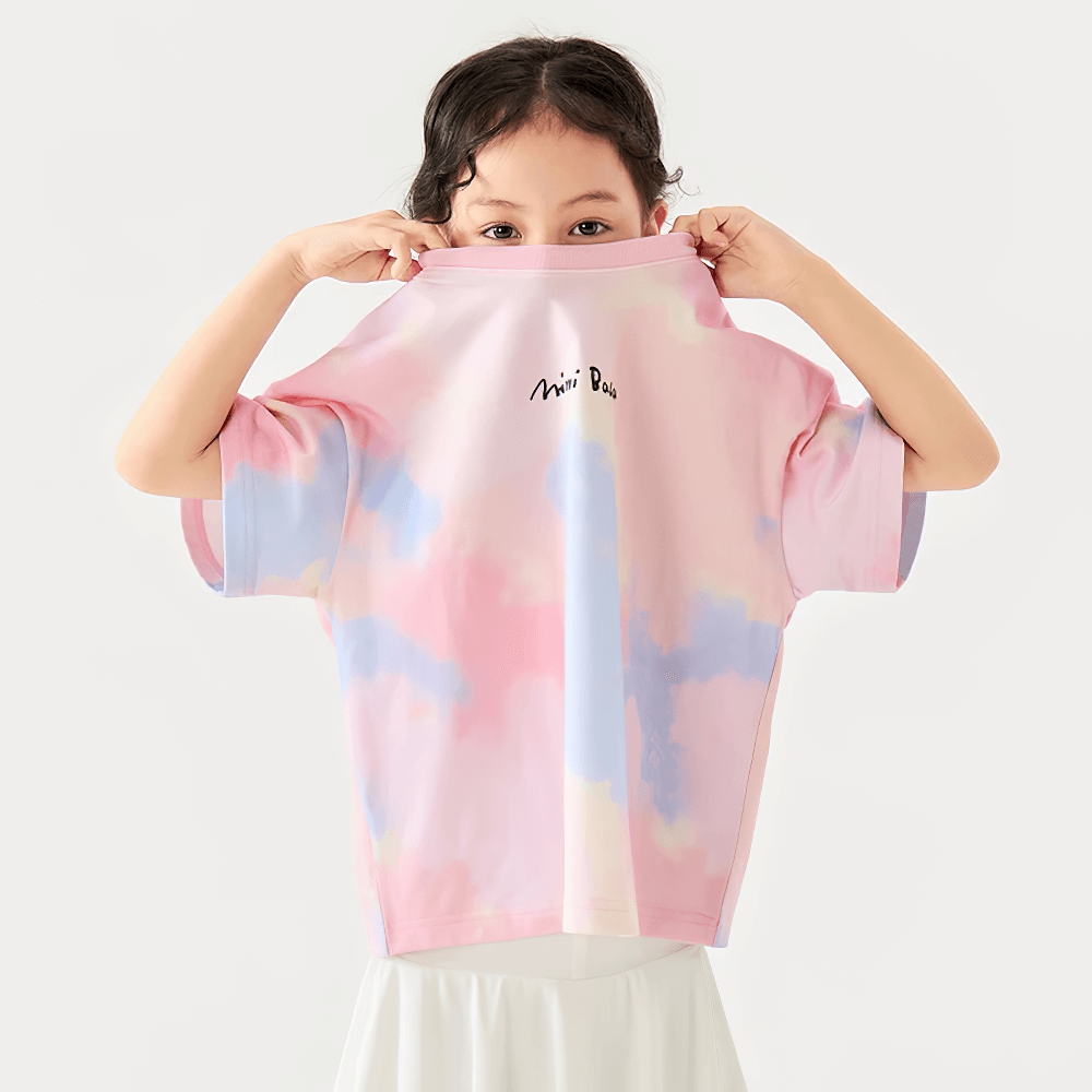 Young girl playfully holding a Breathable Cotton Tie-Dye Tee for Boys and Girls - SF3683 over her face, showcasing its vibrant colors.
