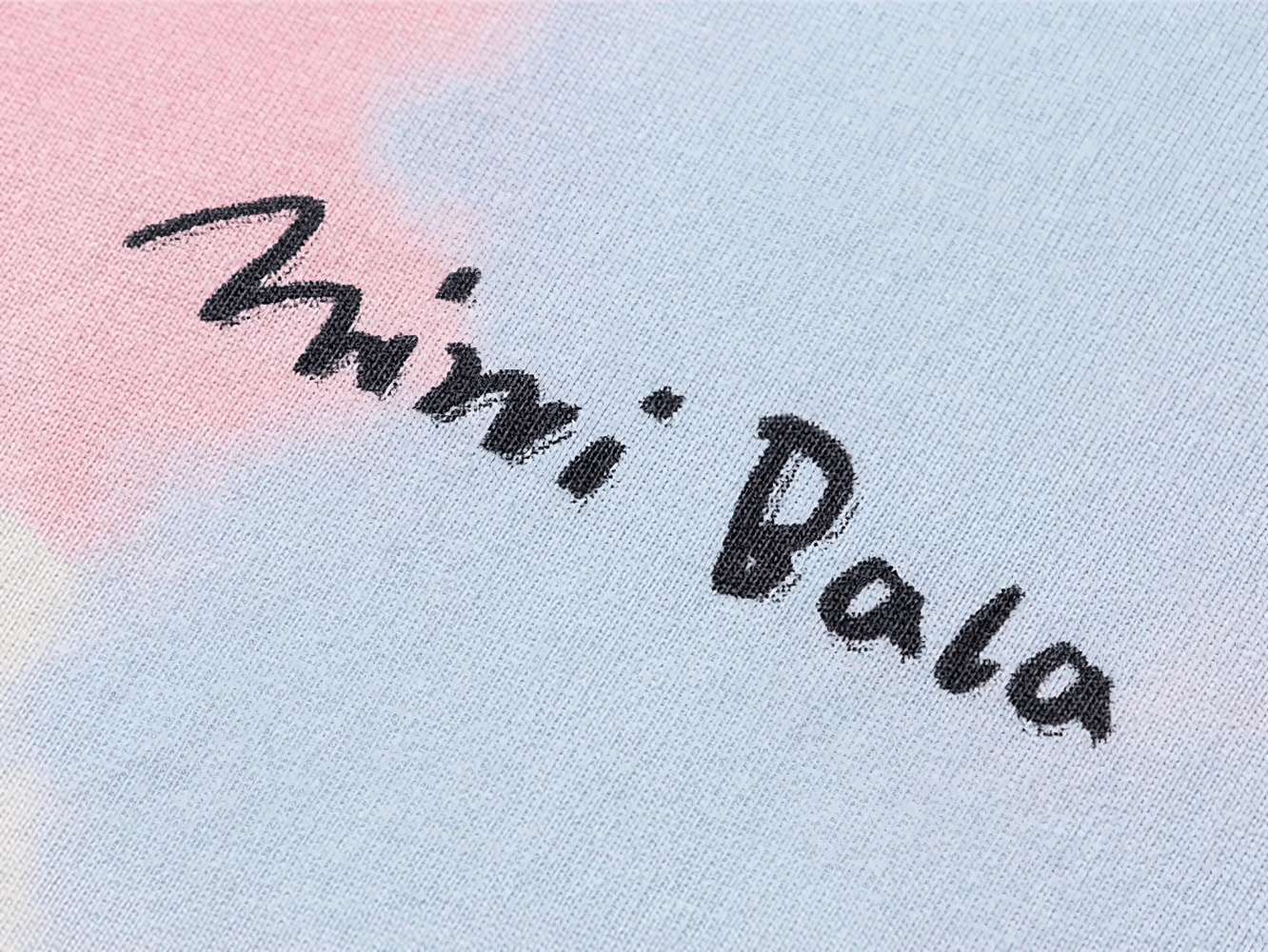 Close-up of tie-dye cotton fabric with 'Mini Bala' text, part of the Breathable Cotton Tie-Dye Tee for Boys and Girls - SF3683.