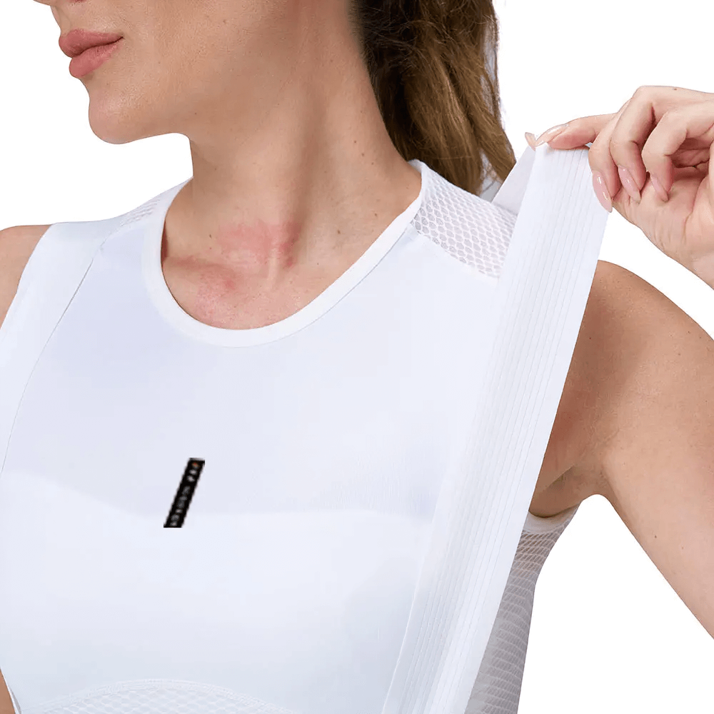 Woman wearing white breathable cycling bib shorts with elastic strap, showcasing slim fit design for long road bike rides.