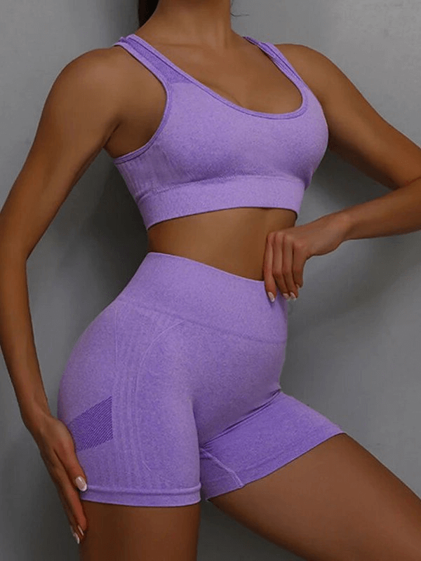 Model wearing breathable elastic women's sports bra and shorts set in lavender, perfect for yoga and exercise.