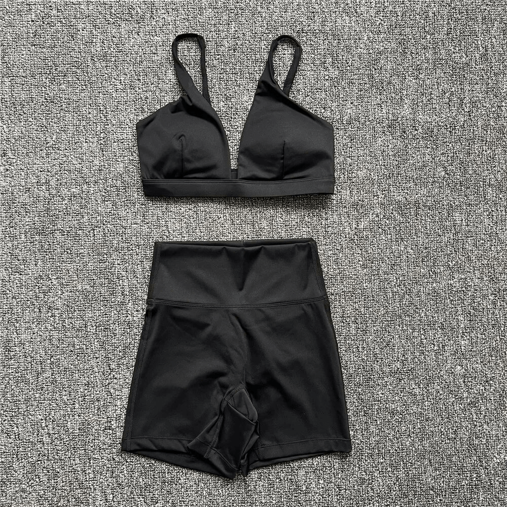 Breathable elastic women's shorts and sports bra set in black, perfect for yoga and fitness activities.