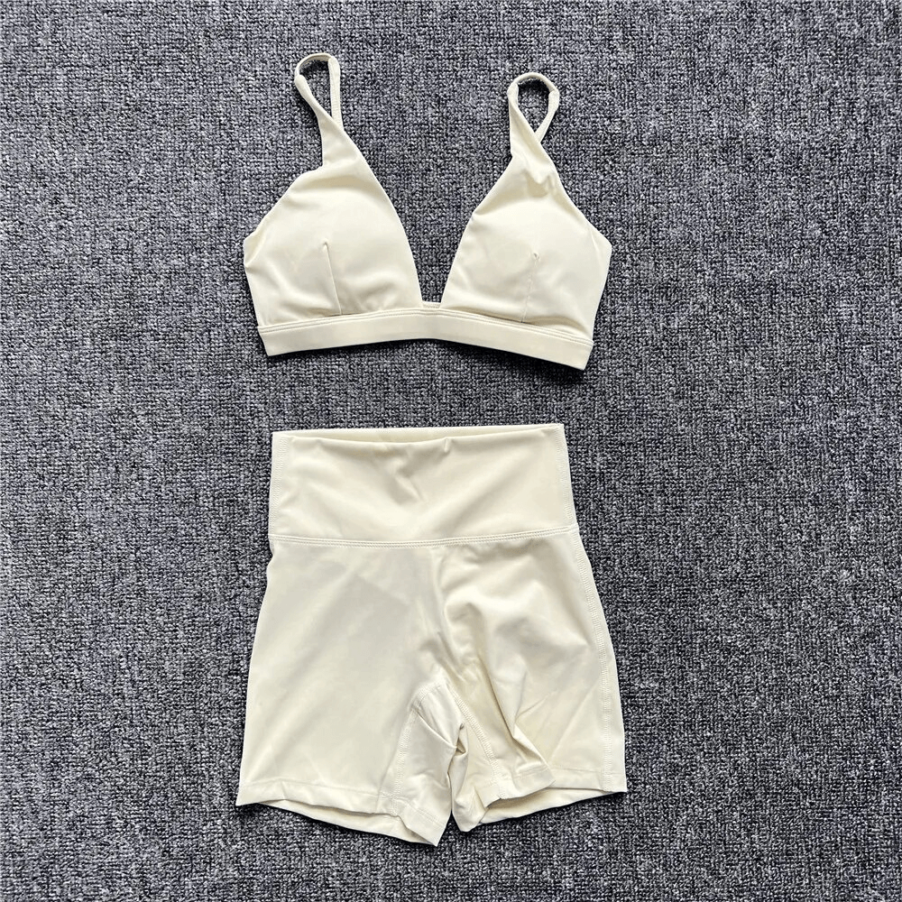 Cream breathable elastic women's sports bra and shorts set on grey background for yoga and workouts - SF1757.