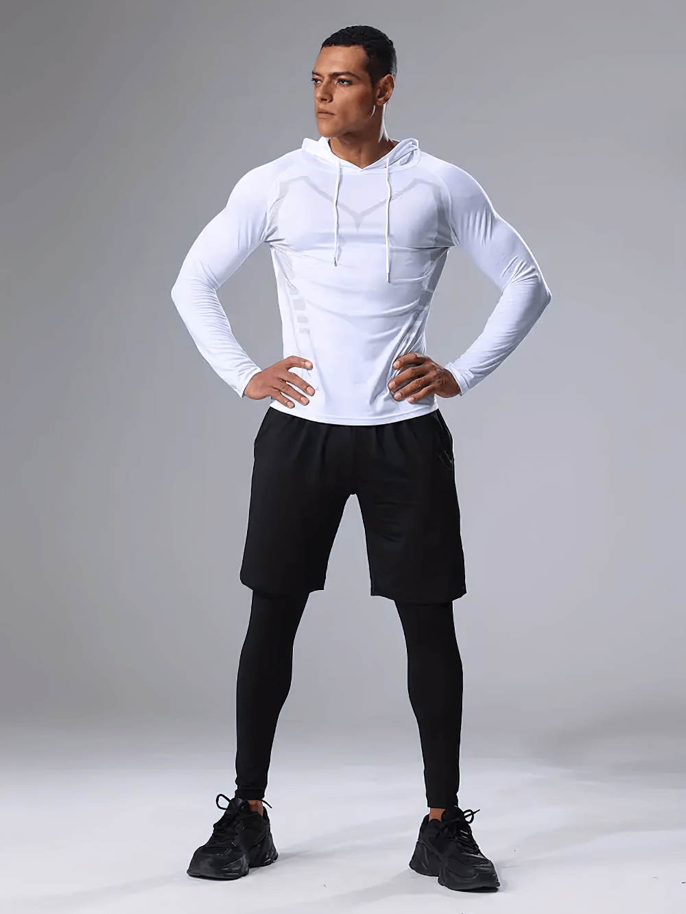 Man wearing breathable men's 3-piece workout set SF2625 with hooded top, shorts, and compression tights for fitness and running.