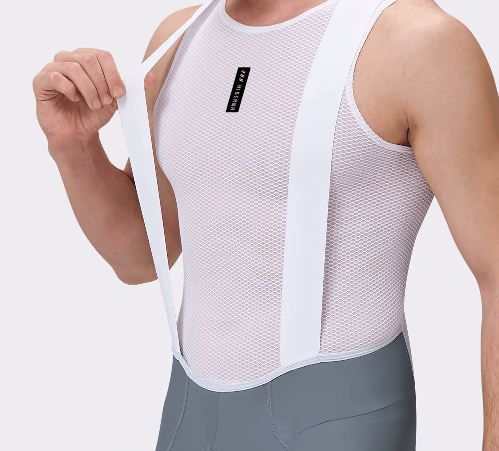 Man wearing breathable men's pro cycling bib shorts with ergonomic design and white mesh top for enhanced comfort and flexibility.