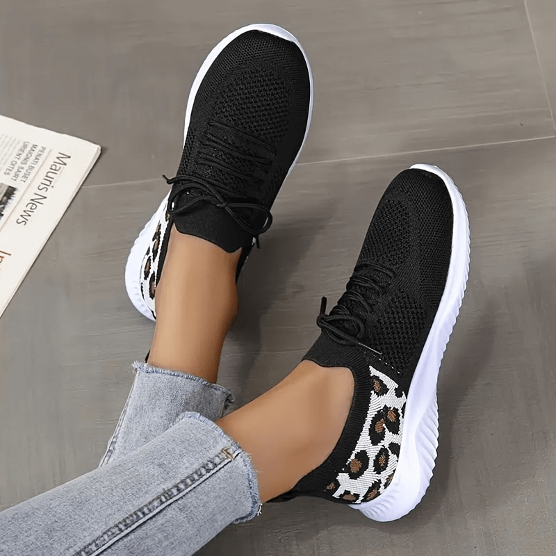 Breathable mesh leopard print soft sole sports sneakers for women, featuring black upper and white soles, perfect for comfort and style.