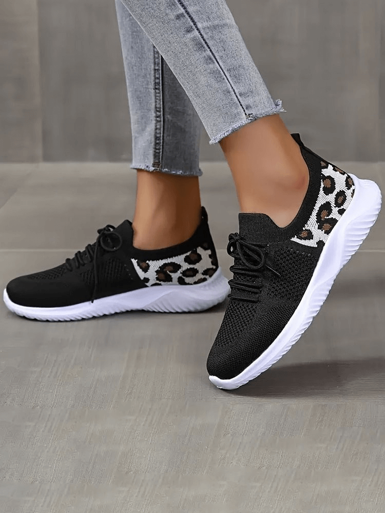 Women's breathable mesh sneakers with leopard print and soft soles, offering style and comfort, shown in chic black and white design.