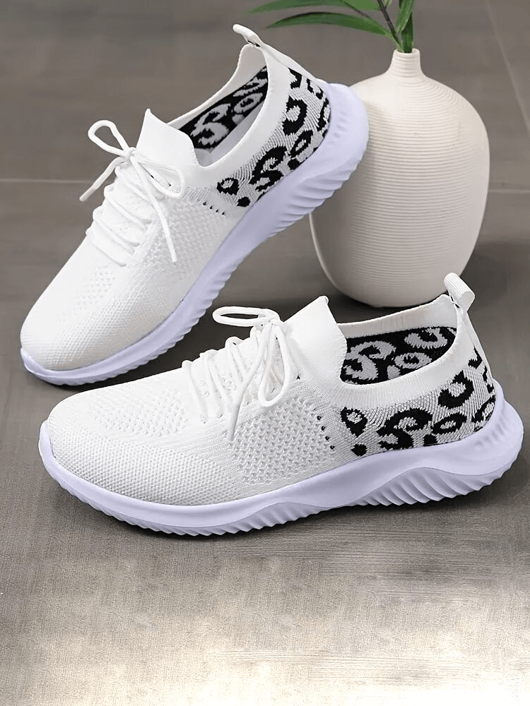 Breathable mesh white sneakers with leopard print, soft sole sports shoes for women, featuring lace-up closure and round toe.